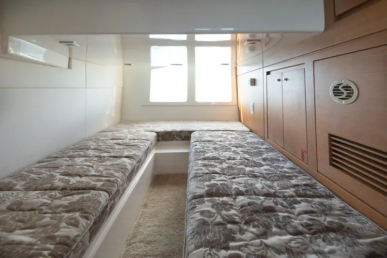  Yacht Photos Pics Interior cabin of a 2018 Schaefer 400 Sport yacht with twin beds and wooden cabinetry.