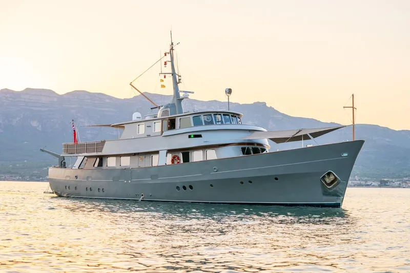 La Fenice Yacht Photos Pics 1962 Laurent Giles TSDMY Gentleman's Motor Yacht on serene water at sunset.