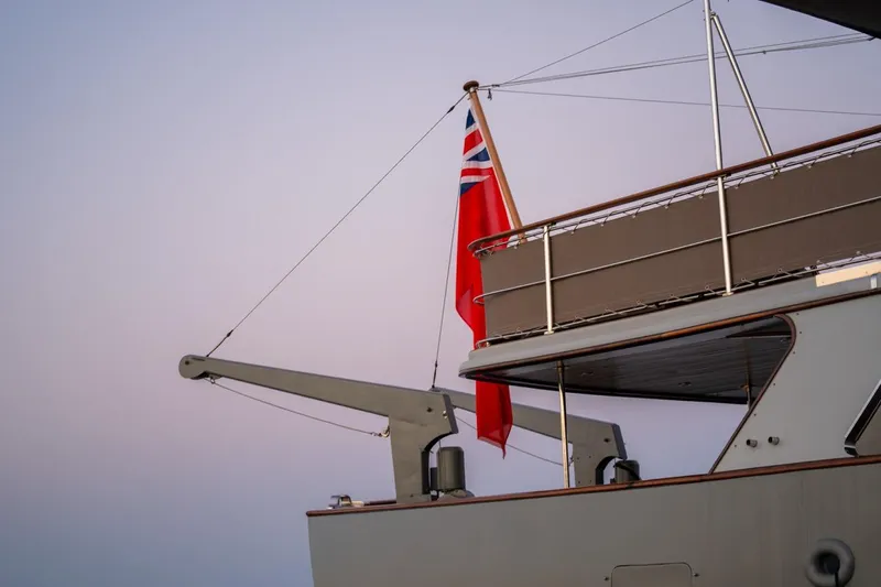 La Fenice Yacht Photos Pics 1962 Laurent Giles TSDMY Gentleman's Motor Yacht with red flag at sunset.