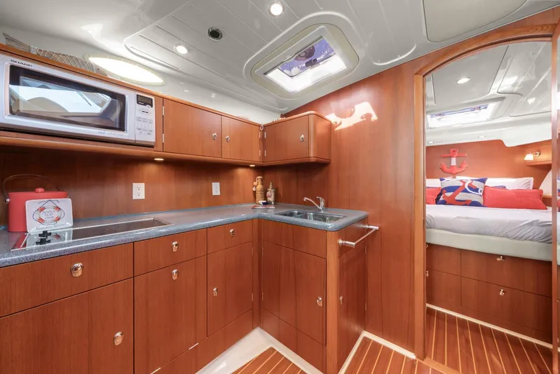 Lady Di Yacht Photos Pics Luxurious 2007 Oyster LD43 yacht interior with modern kitchen and cozy bedroom.