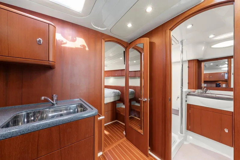 Lady Di Yacht Photos Pics Interior of 2007 Oyster LD43 yacht with wooden cabinetry and modern fixtures.