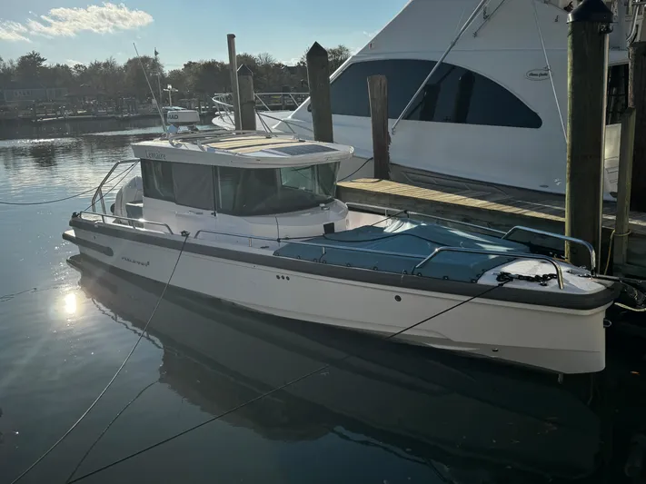 Lemaire Yacht Photos Pics 2023 Axopar 28 CABIN boat docked in a marina, side view.