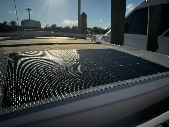 Lemaire Yacht Photos Pics Solar panel on 2023 Axopar 28 CABIN boat under sunlight at dock.