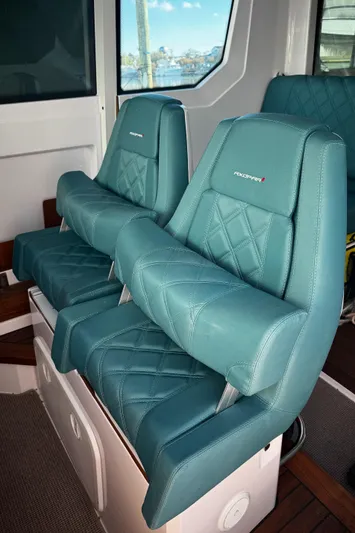 Lemaire Yacht Photos Pics 2023 Axopar 28 CABIN interior with teal quilted seats.