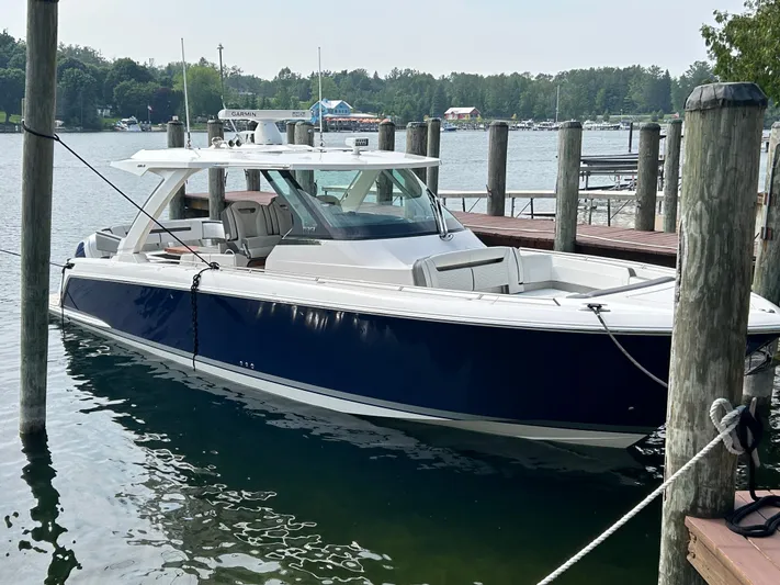  Yacht Photos Pics 2019 Tiara Yachts 38 LS docked, featuring sleek design and blue hull.