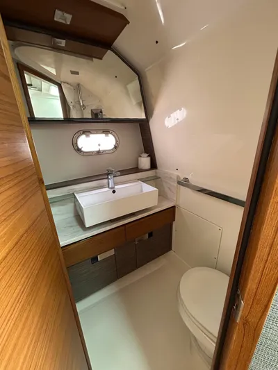  Yacht Photos Pics 2019 Tiara Yachts 38 LS bathroom with modern sink and wooden accents.