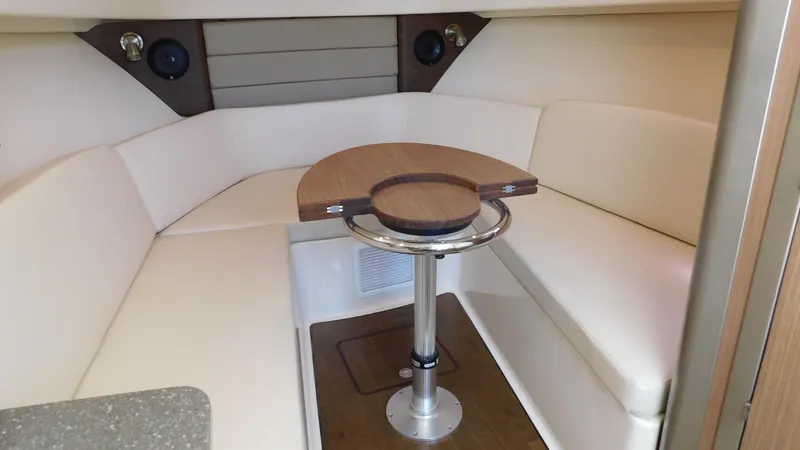  Yacht Photos Pics 2017 Boston Whaler 315 Conquest cabin interior with seating and table.