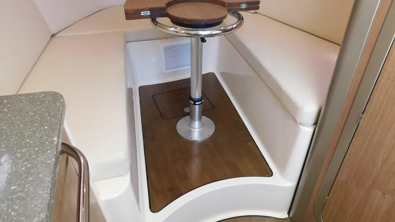  Yacht Photos Pics 2017 Boston Whaler 315 Conquest cabin interior with seating and table.