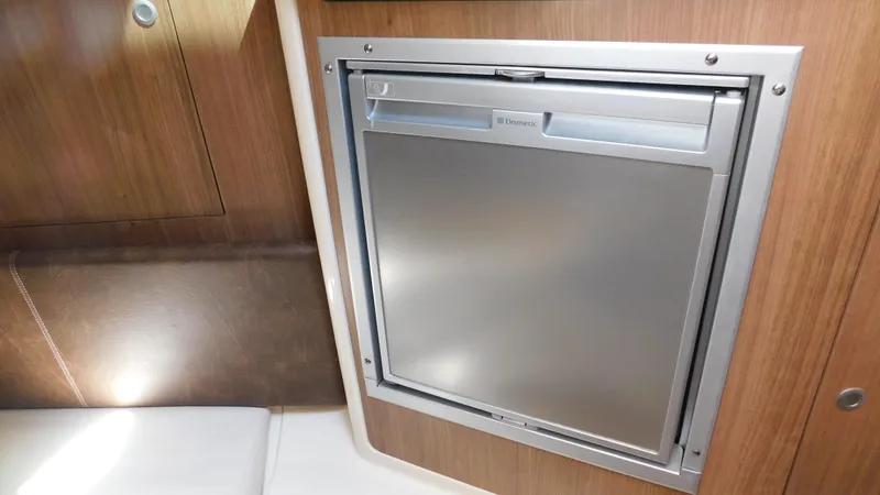  Yacht Photos Pics 2017 Boston Whaler 315 Conquest interior with built-in stainless steel refrigerator.