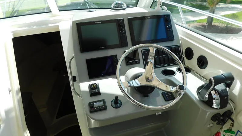  Yacht Photos Pics 2017 Boston Whaler 315 Conquest helm with dual screens and steering wheel.