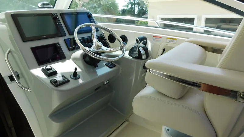  Yacht Photos Pics 2017 Boston Whaler 315 Conquest helm with modern controls and navigation screens.