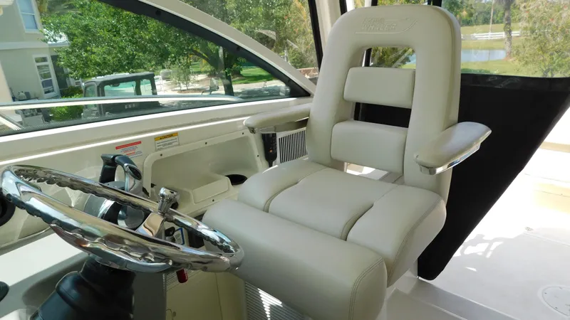  Yacht Photos Pics Captain's chair and steering wheel on 2017 Boston Whaler 315 Conquest boat.