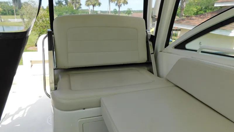  Yacht Photos Pics 2017 Boston Whaler 315 Conquest interior seating with beige upholstery and outdoor view.