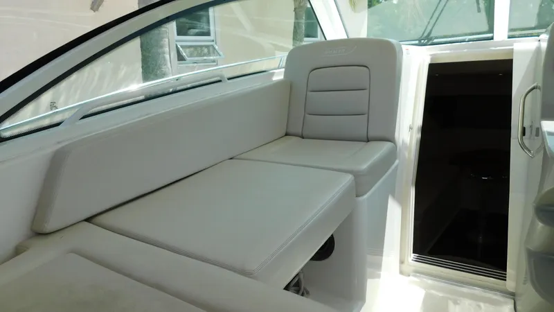  Yacht Photos Pics 2017 Boston Whaler 315 Conquest interior with white seating and cabin entrance.
