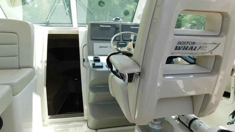  Yacht Photos Pics 2017 Boston Whaler 315 Conquest helm with steering wheel and controls.