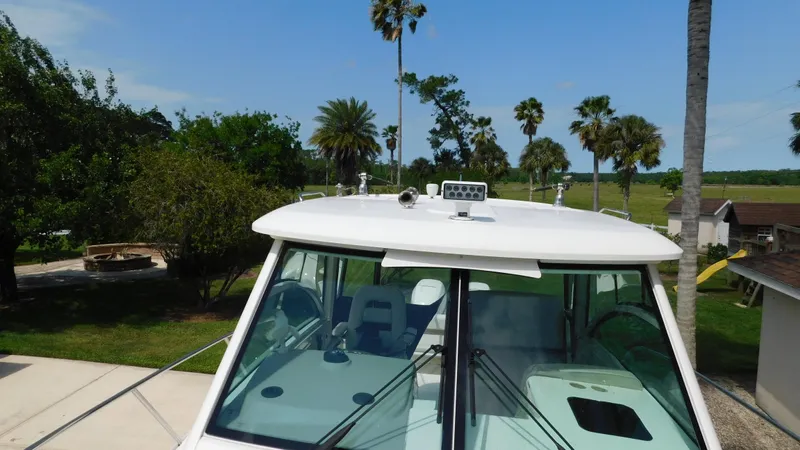  Yacht Photos Pics 2017 Boston Whaler 315 Conquest boat with palm trees in the background.