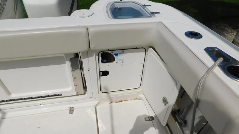  Yacht Photos Pics 2017 Boston Whaler 315 Conquest boat interior, featuring storage compartments and seating area.