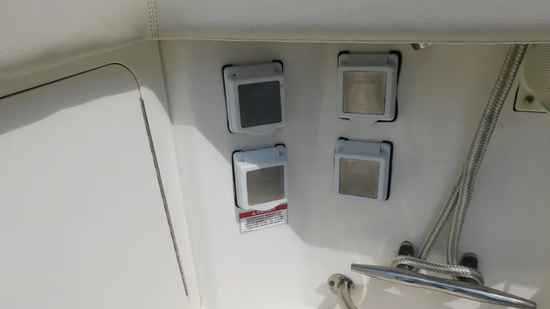  Yacht Photos Pics 2017 Boston Whaler 315 Conquest boat panel with four covered switches and ropes.