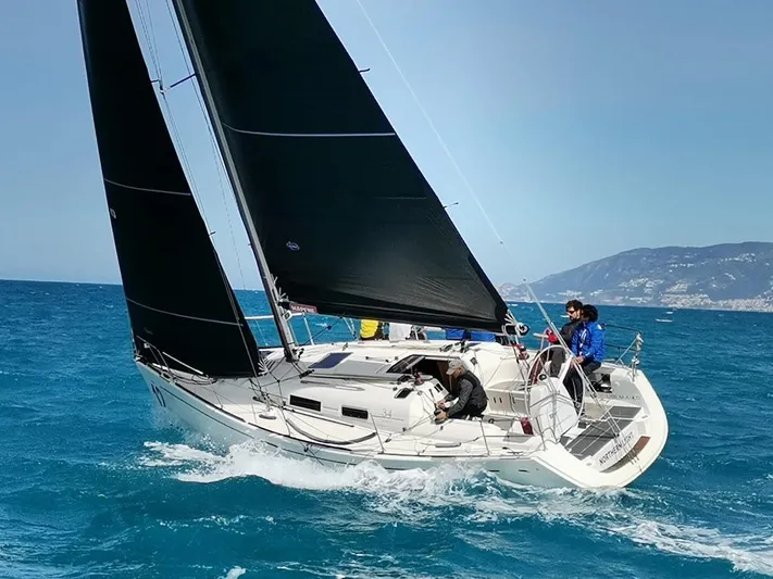  Yacht Photos Pics 2004 Dufour 34 Performance sailboat navigating blue ocean waters.