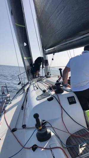  Yacht Photos Pics Sailing on a 2004 Dufour 34 Performance yacht, open sea, crew adjusting sails.