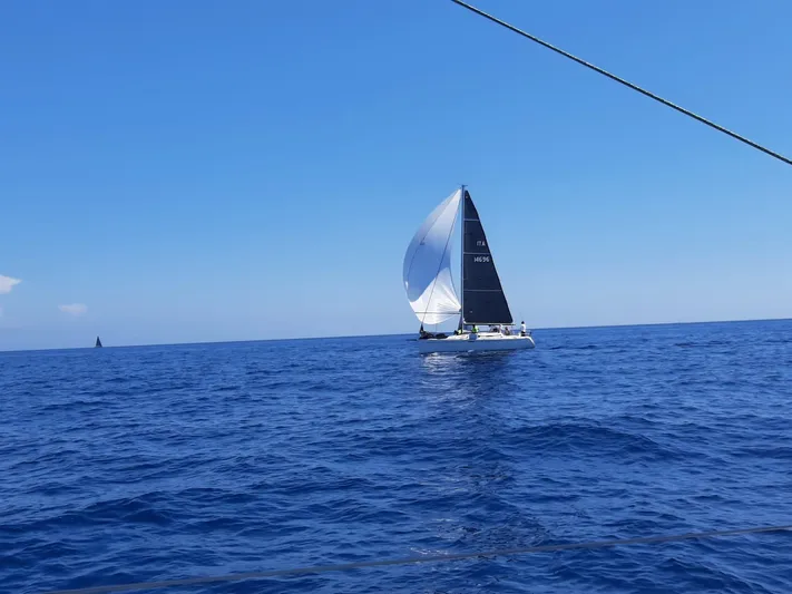  Yacht Photos Pics Sailing yacht Dufour 34 Performance 2004 on open sea under clear blue sky.