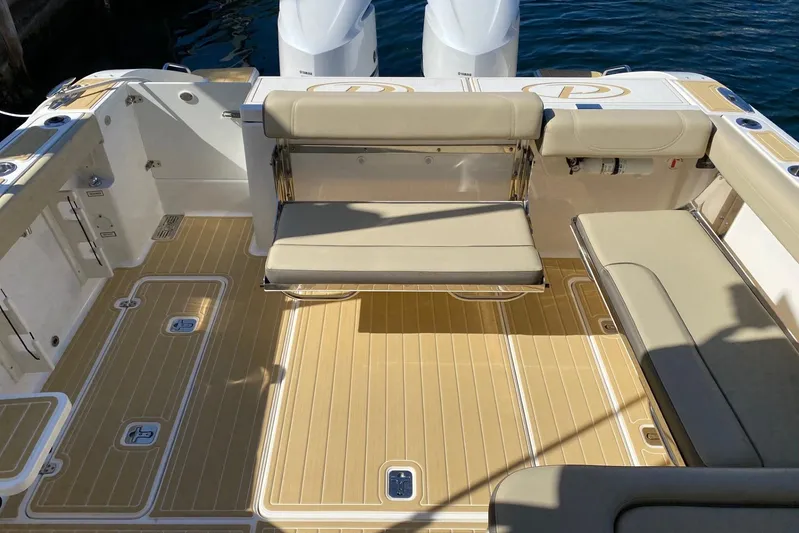 Perfect Draw Yacht Photos Pics 2020 Pursit DC 325 boat interior with beige seating and teak-style flooring.