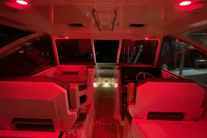 Perfect Draw Yacht Photos Pics Interior of 2020 Pursit DC 325 boat with red ambient lighting.