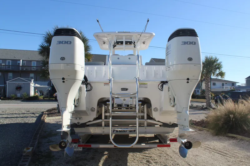  Yacht Photos Pics Rear view of a 2022 Twin Vee 280 GFX boat with dual outboard engines.