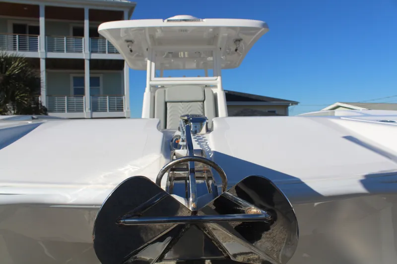  Yacht Photos Pics 2022 Twin Vee 280 GFX boat with anchor, blue sky.