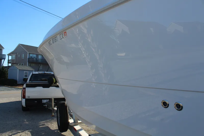  Yacht Photos Pics 2022 Twin Vee 280 GFX boat on trailer, residential background.