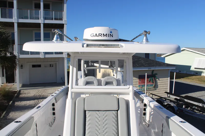  Yacht Photos Pics 2022 Twin Vee 280 GFX boat with Garmin equipment, parked in front of a house.