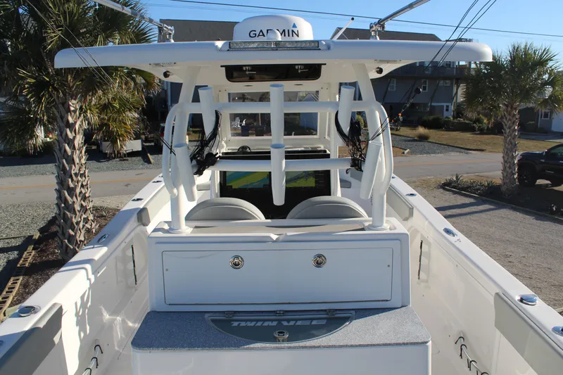  Yacht Photos Pics 2022 Twin Vee 280 GFX boat with Garmin equipment, palm trees in background.