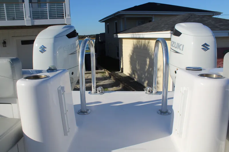  Yacht Photos Pics 2022 Twin Vee 280 GFX boat with Suzuki engines, docked at harbor.