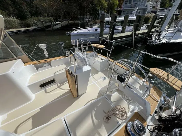 #14 Yacht Photos Pics 2024 Tartan 395 sailboat cockpit with dual steering wheels, docked at a marina.