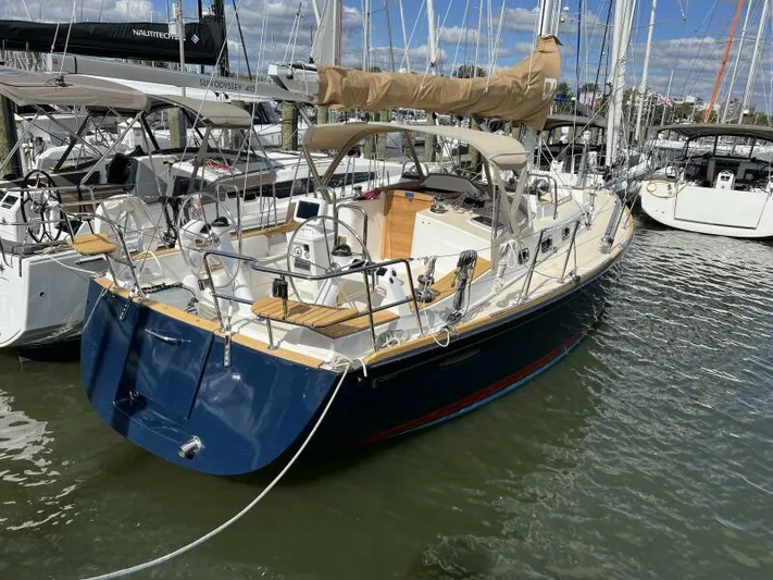 #14 Yacht Photos Pics 2024 Tartan 395 sailboat docked in marina, featuring sleek design and spacious deck.