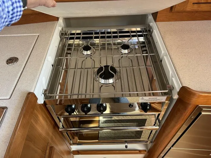 #14 Yacht Photos Pics Modern kitchen stove in 2024 Tartan 395 yacht, featuring three burners and sleek design.