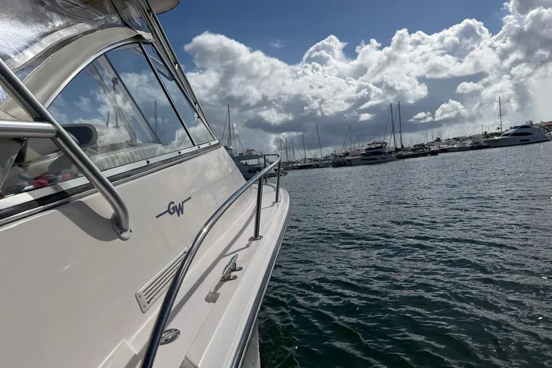  Yacht Photos Pics 2009 Grady-White Express 330 boat docked in a marina under cloudy skies.