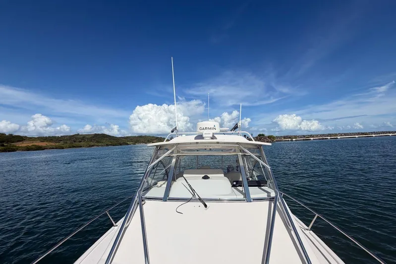  Yacht Photos Pics 2009 Grady-White Express 330 boat on calm water under clear blue sky.