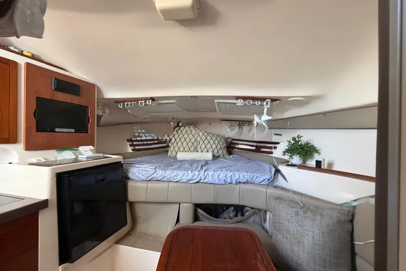  Yacht Photos Pics 2009 Grady-White Express 330 cabin interior with bed, TV, and kitchenette.