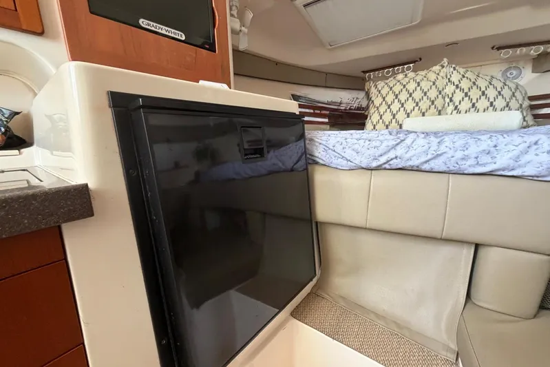  Yacht Photos Pics 2009 Grady-White Express 330 interior with bed, fridge, and cabinetry.