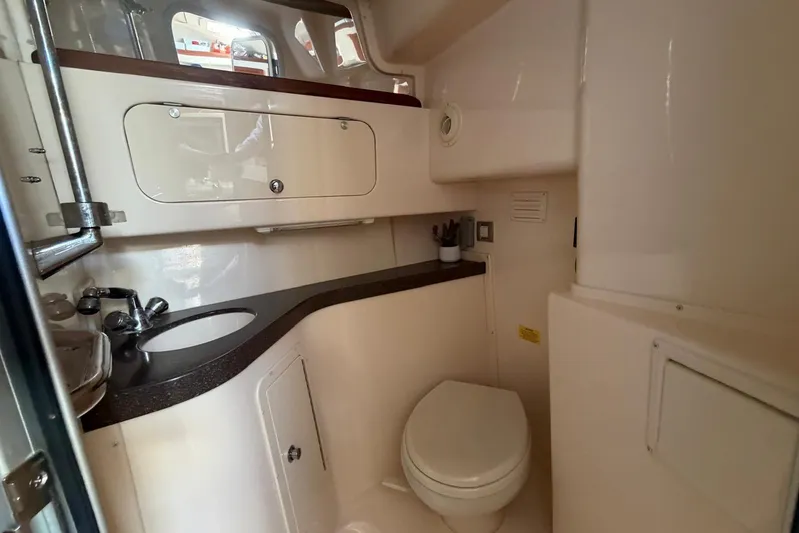  Yacht Photos Pics 2009 Grady-White Express 330 boat bathroom with sink, toilet, and storage cabinets.