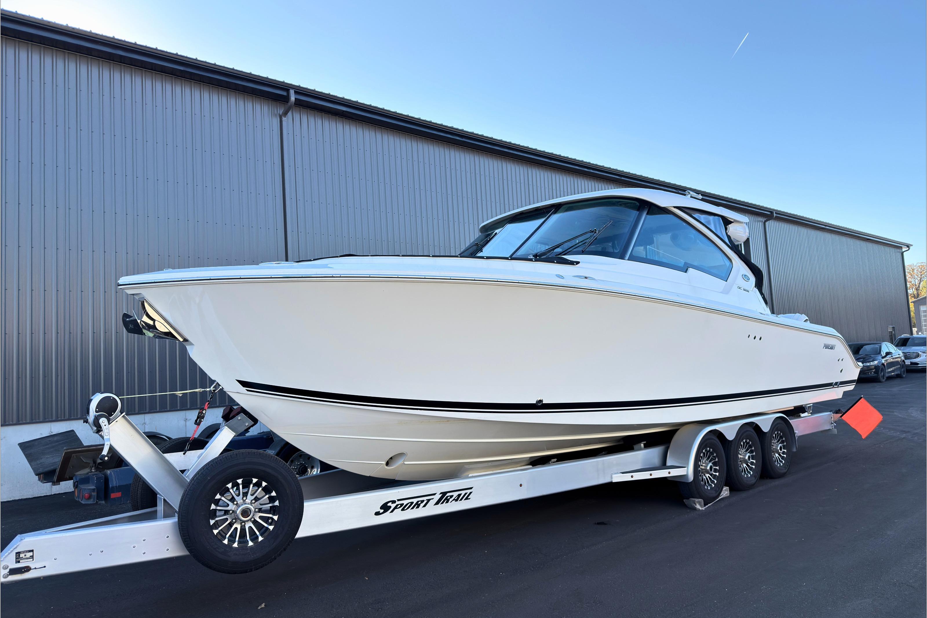 2021 Pursuit DC 326 Dual Console boat on trailer, parked outdoors.