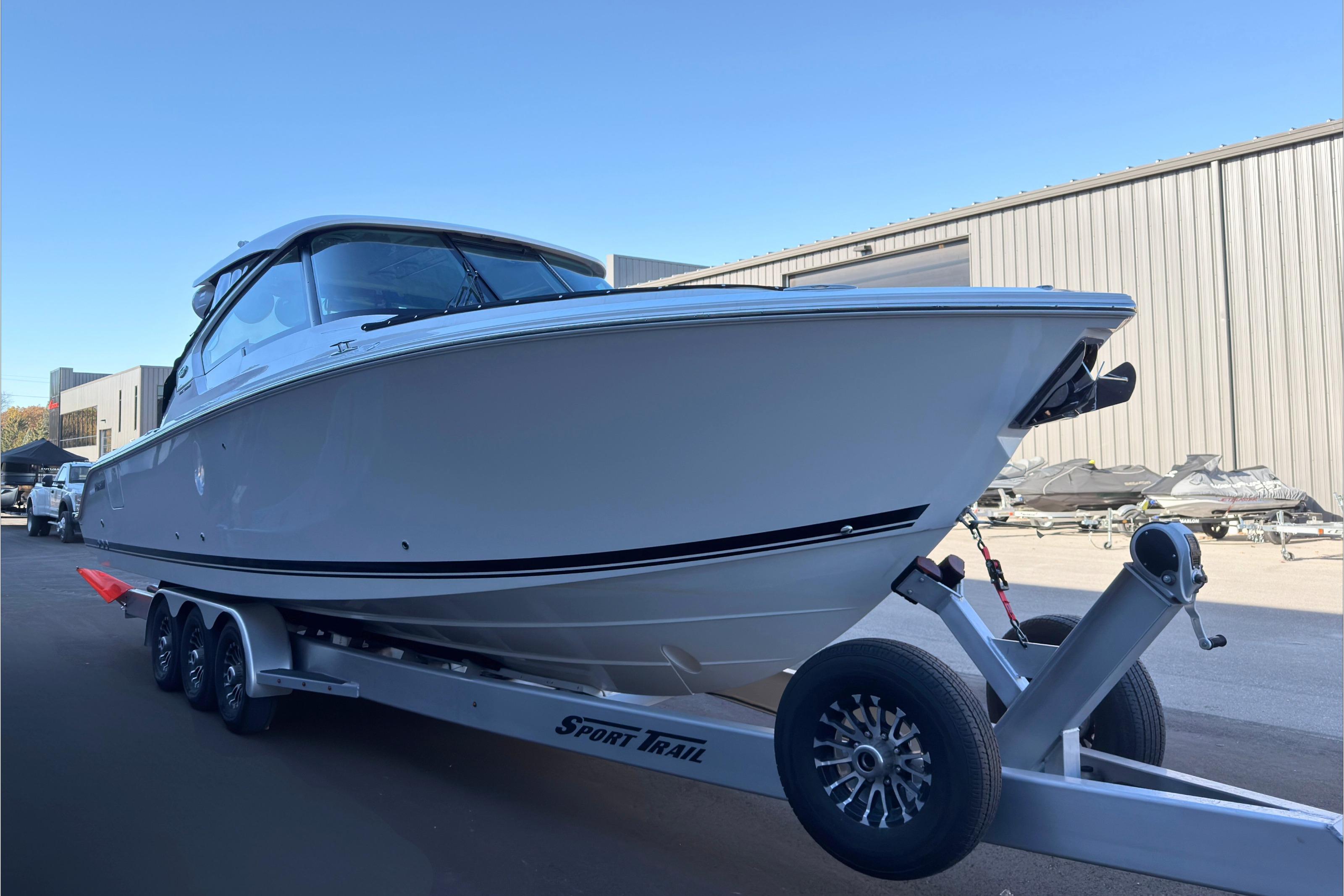 2021 Pursuit DC 326 Dual Console boat on trailer, parked outdoors.