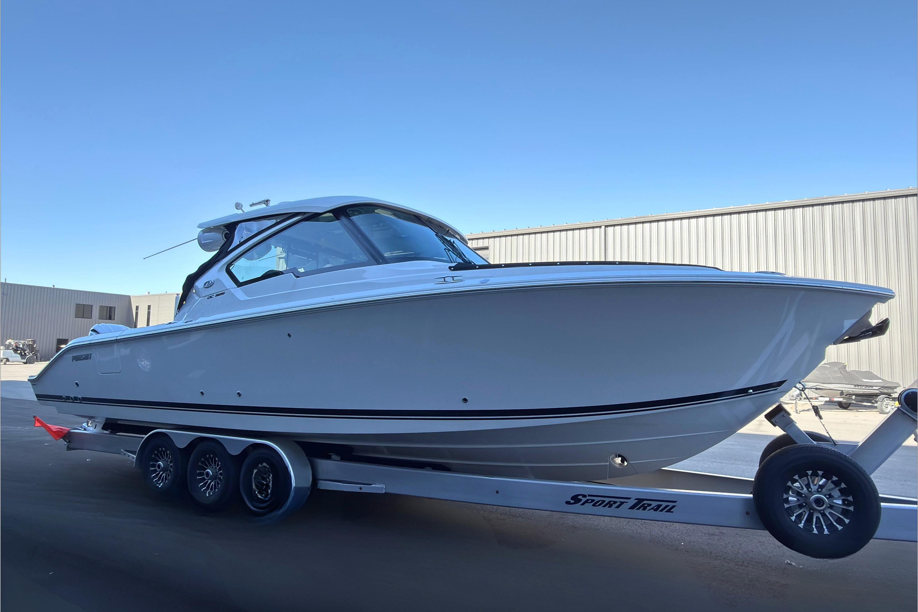 2021 Pursuit DC 326 Dual Console boat on trailer, side view.