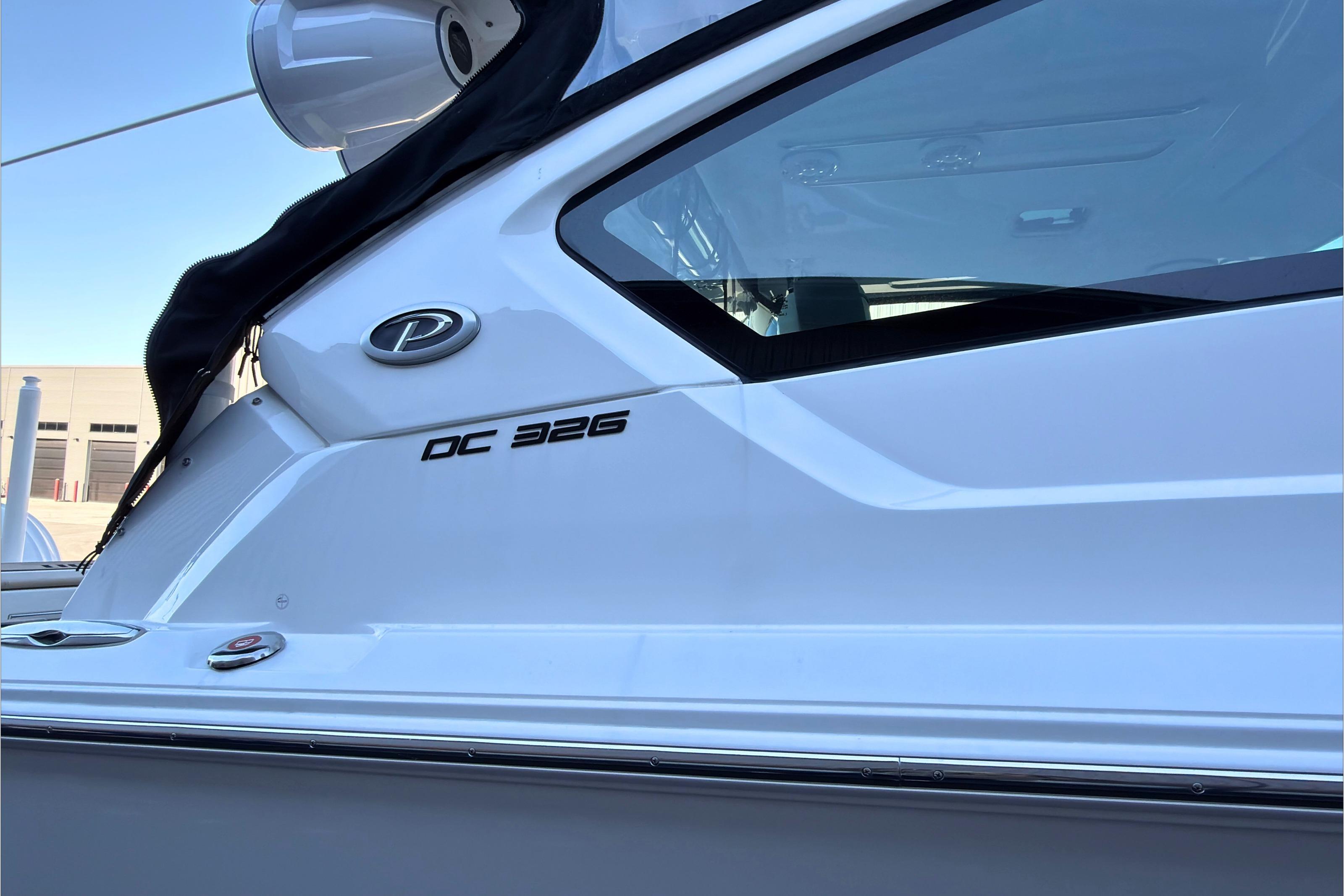 2021 Pursuit DC 326 Dual Console boat side view with logo and window.
