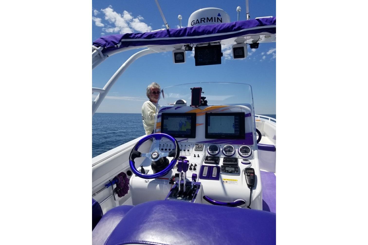 2014 Concept Boats 36CC dashboard with navigation equipment, purple accents, and ocean view.