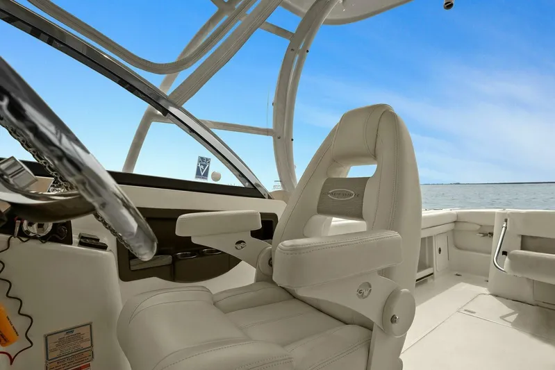 Patsy Ru Yacht Photos Pics 2016 Grady-White 285 Freedom boat interior with helm and seating, under clear blue sky.