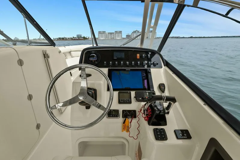 Patsy Ru Yacht Photos Pics 2016 Grady-White 285 Freedom boat cockpit with steering wheel and control panel.