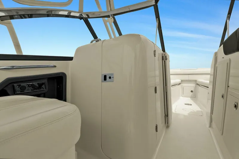 Patsy Ru Yacht Photos Pics 2016 Grady-White 285 Freedom boat interior with seating and storage, under a clear blue sky.