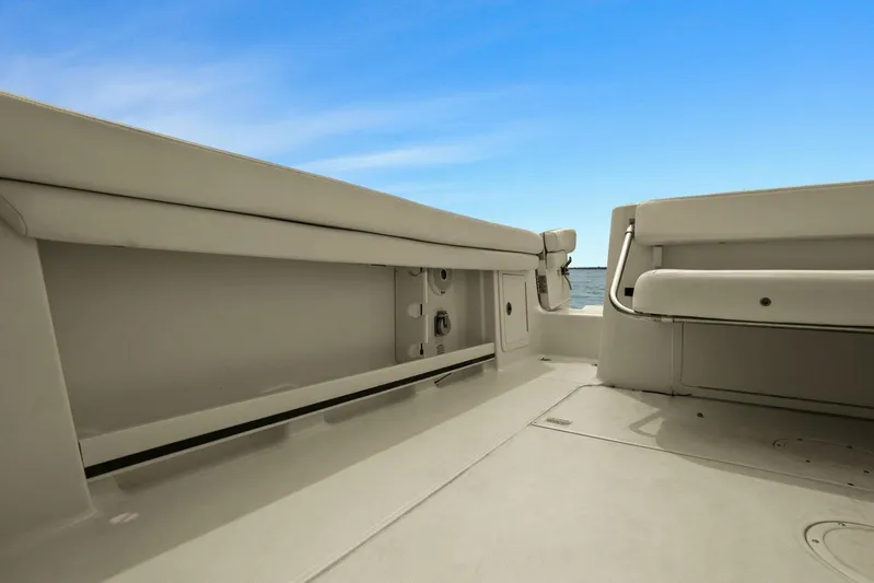 Patsy Ru Yacht Photos Pics 2016 Grady-White 285 Freedom boat interior with seating and storage, under clear blue sky.
